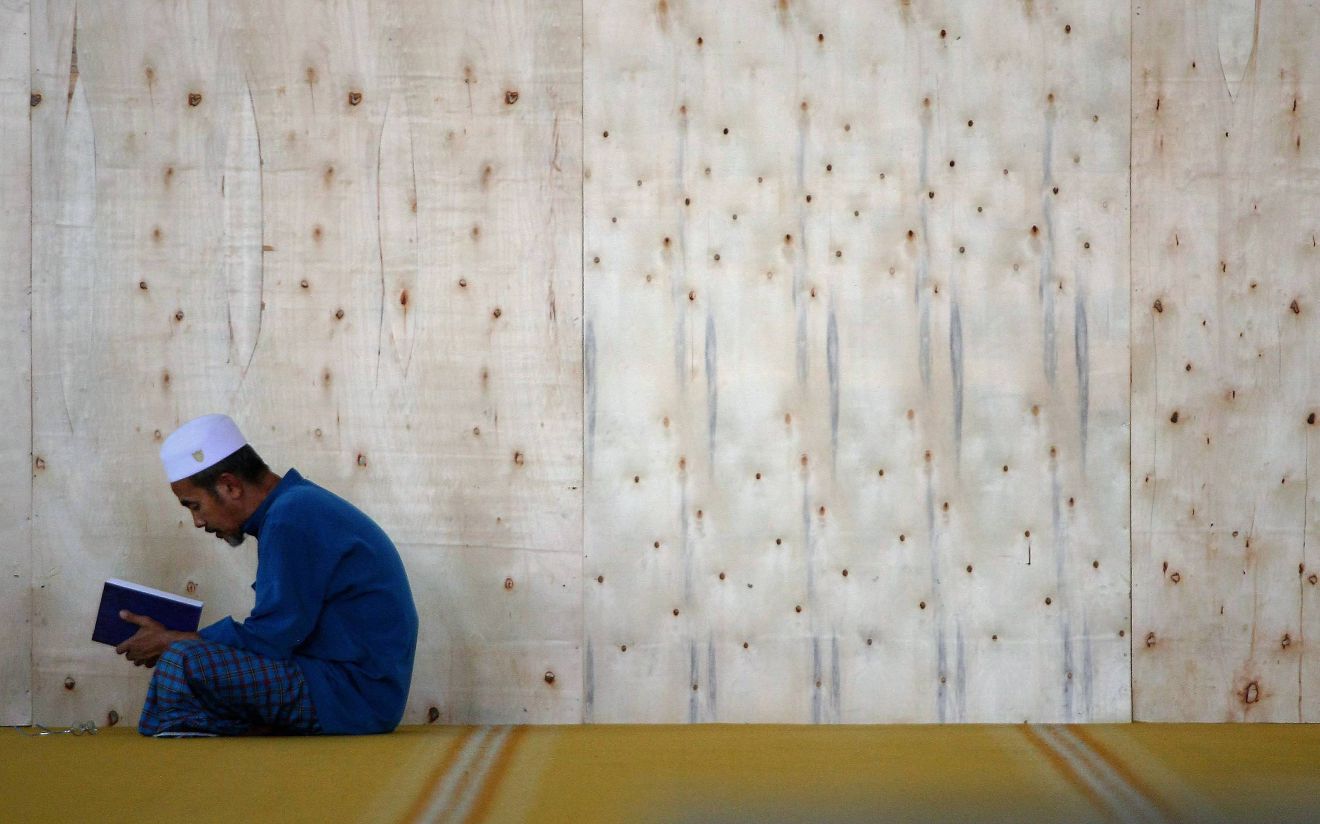 Man-reading-Quran-learning-student