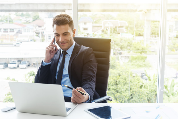 Someone talking on the phone in his office-Can I Talk to My Fiance before Marriage in Islam