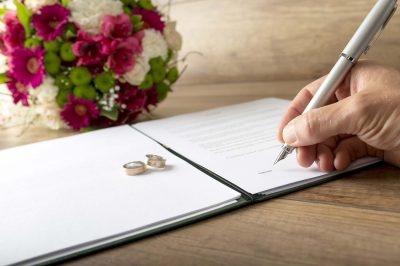Someone signing marriage contract