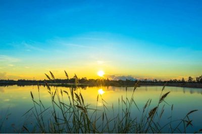 Sunset landscape with blue sky at the calm lake