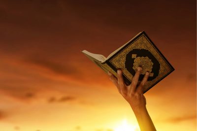 someone holding the quran in his hands