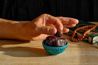 someone taking dates from a dish