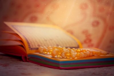 Sacred Book of the Quran and prayer beads